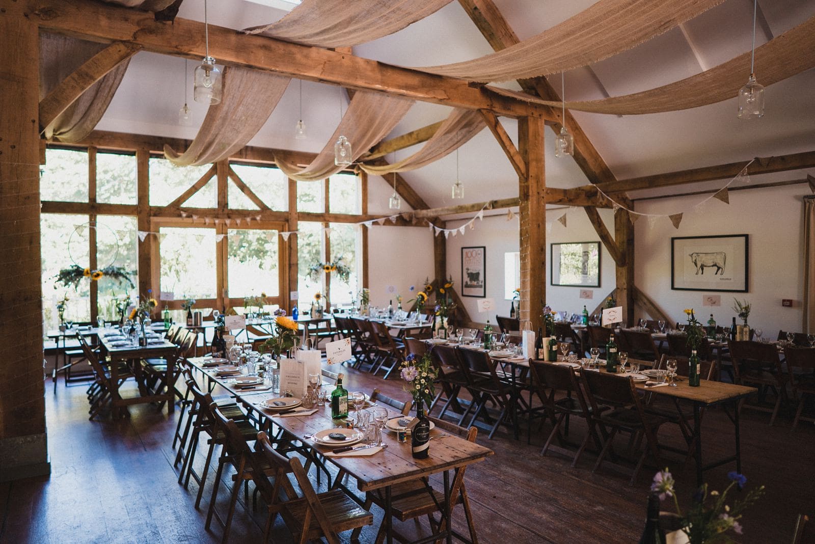 Nancarrow Farm's Oak Barn laid up with trestle tables for a wedding breakfast